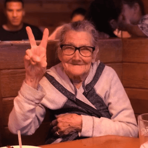 Patricia throwing up a peace sign.